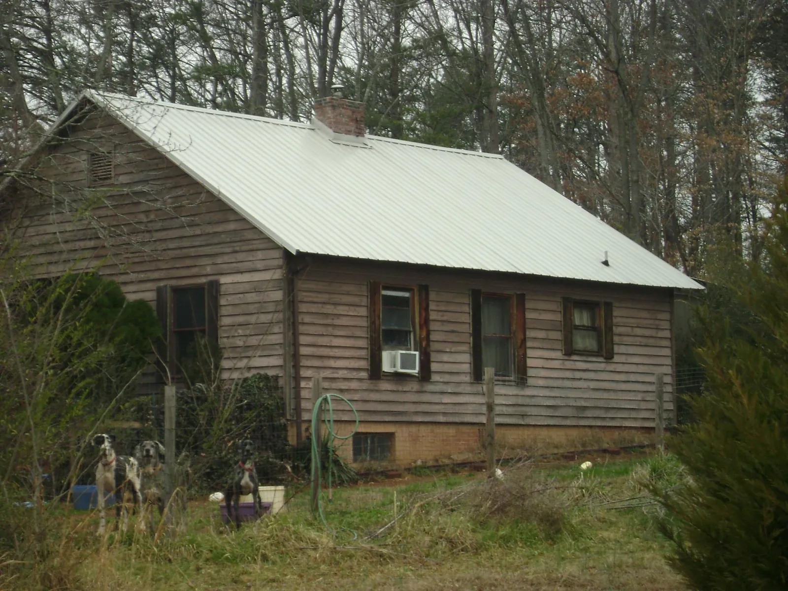 White metal roof on an old wood sided farmhouse, from a Metal Roof Installation job in Bolton